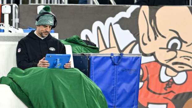 aaron rodgers sitting under a blanket