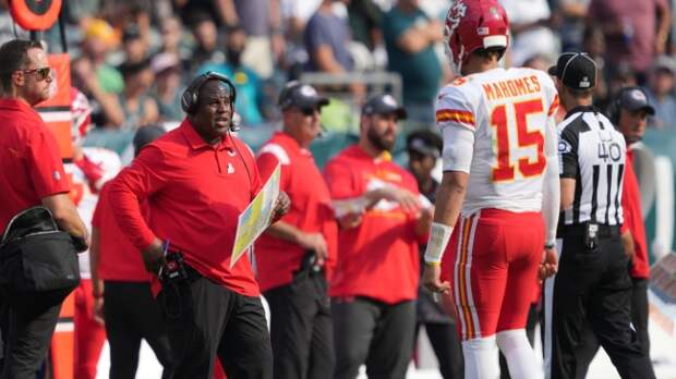 Patrick Mahomes talks to coaches on the sideline.