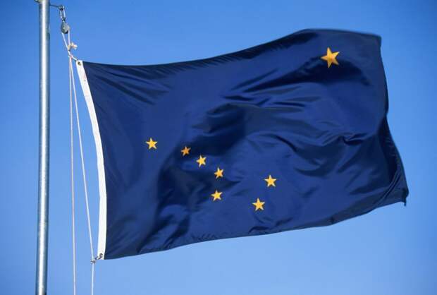 Flag of Alaska on the mast against the sky