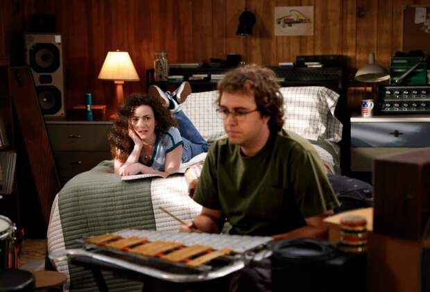 Connor plays his xylophone while Chloe watches from the bed on Georgie & Mandy's First Marriage Season 1 Episode 18