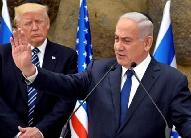 Israeli Prime Minister Benjamin Netanyahu gestures as he speaks to the media while U.S. President Donald Trump listens at the Yad Vashem Holocaust Museum in Jerusalem May 23, 2017. REUTERS/Debbie Hill/Pool - RTX3783K