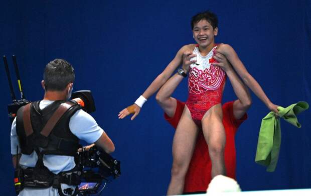 China’s Quan, 14, wins Olympic gold with three perfect dives
