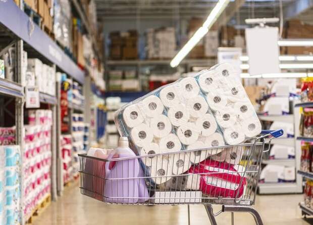 A shopping cart full of cleaning products in a big-box store.