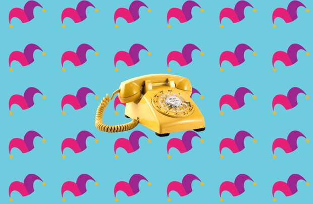 A yellow rotary phone against a blue background