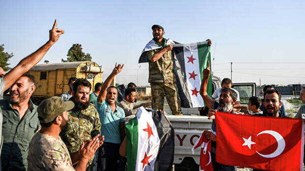 Бойцы поддерживаемой Турцией сирийской вооруженной оппозиции празднуют взятие города Телль-Абъяд.