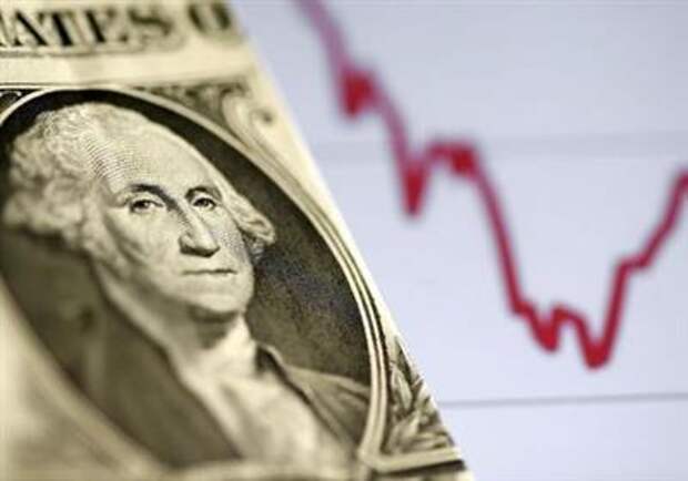 A U.S. dollar note is seen in front of a stock graph in this November 7, 2016 picture illustration. REUTERS/Dado Ruvic/Illustration