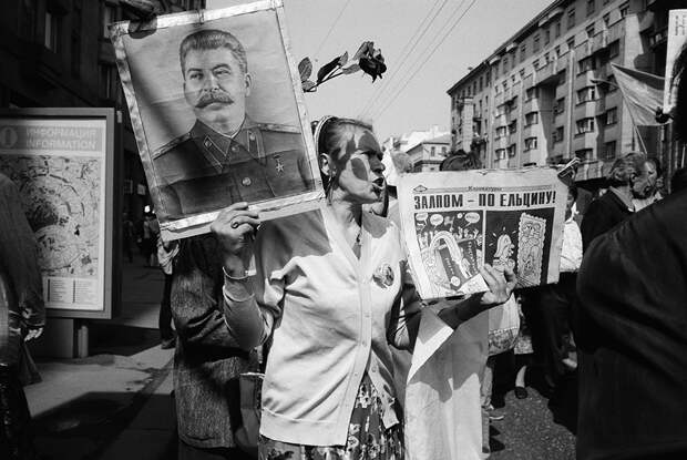 «Я запомнил эту старушку, потому что на Тверской тогда появились новые рекламные билборды, и тут такое совпадение — новая реклама и протестный митинг, так же, как и на фотографии 1998 года, только тут виден фасад других зданий», — рассказывает Мухин. 9 мая, Тверская улица. 1996 год