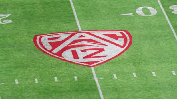 A PAC 12 logo on a football field.