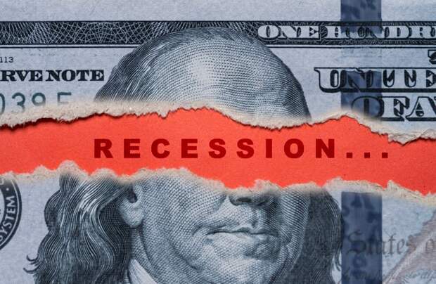 Part of a hundred-dollar bill ripped away to show the word Recession.