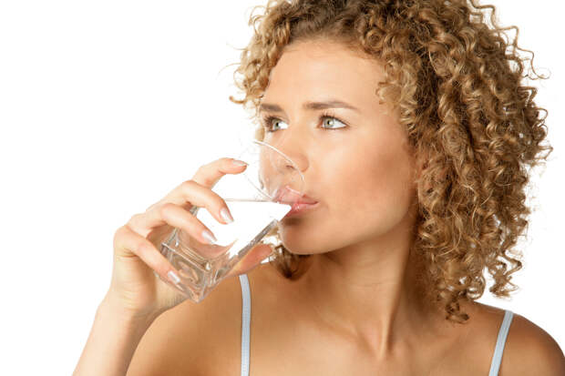 Portrait of young woman drinking water