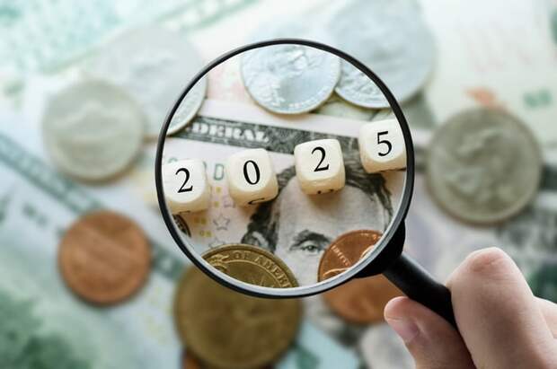 A magnifying glass held over blocks showing the year 2025.