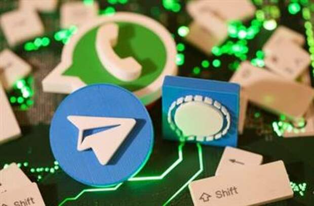 3D printed Telegram, Signal and WhatsApp logos and keyboard buttons are placed on a computer motherboard in this illustration taken January 21, 2021. REUTERS/Dado Ruvic/Illustration 