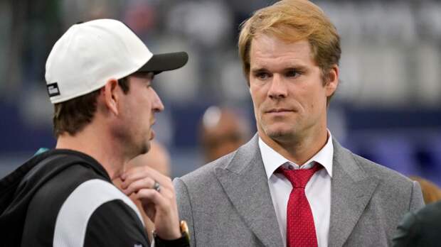 Greg Olsen talks on the sidelines.