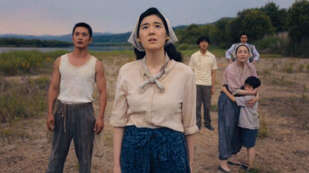 Horizontal shot of Kyunghee and family looking up at planes