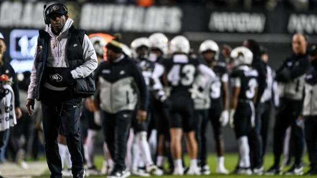 Deion Sanders walks the sidelines during a game between Colorado and Washington State.