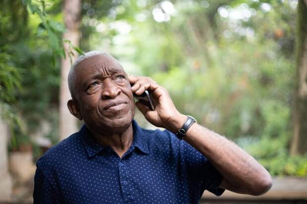 Frustrated person holding phone to their ear.