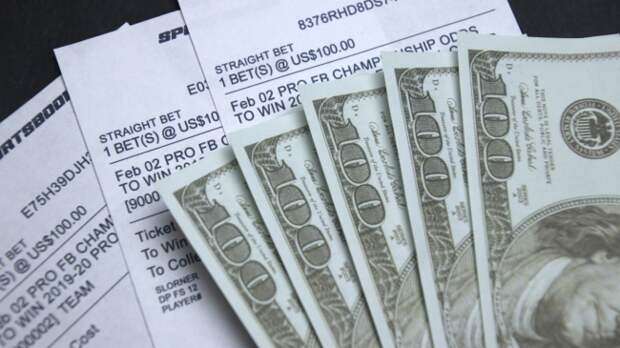 A number of betting slips accompanied by cash.