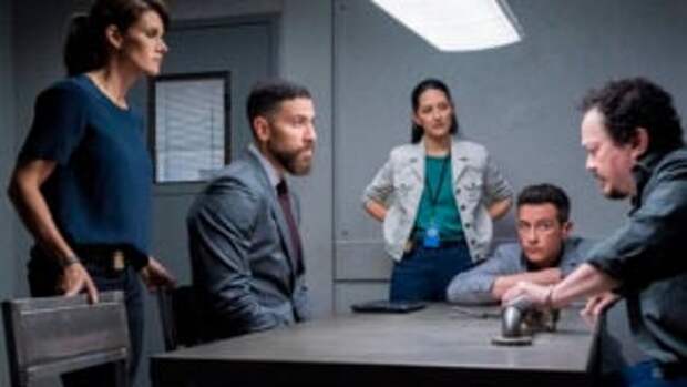 The team talks around a table