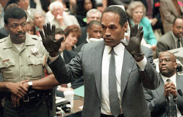 OJ Simpson shows the jury pair of gloves