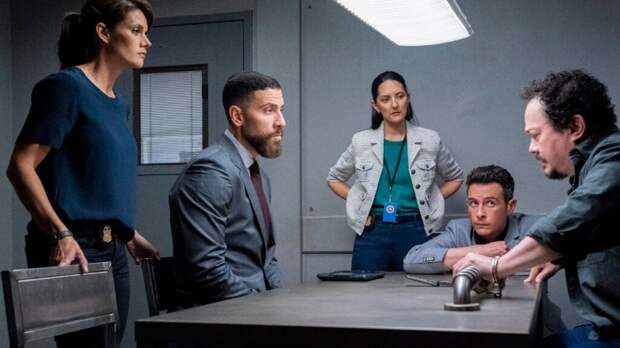 The team talks around a table