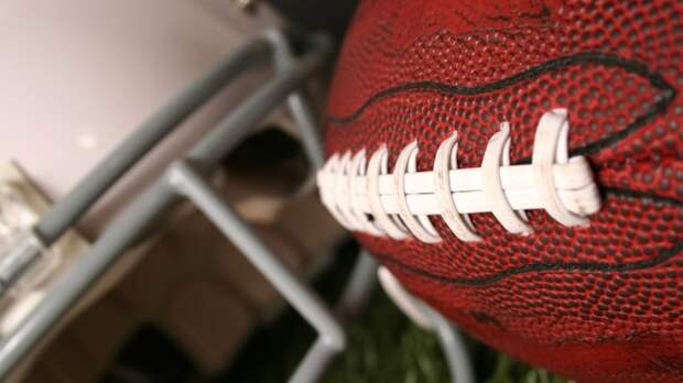 football and helmet on grass