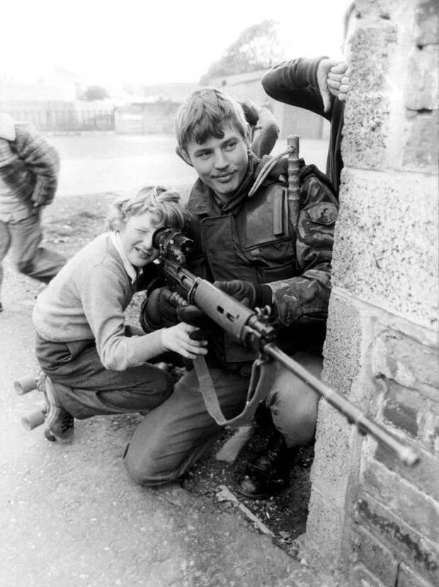 Британский солдат позволяет мальчику взглянуть на прицел в Белфасте, 1981 год.