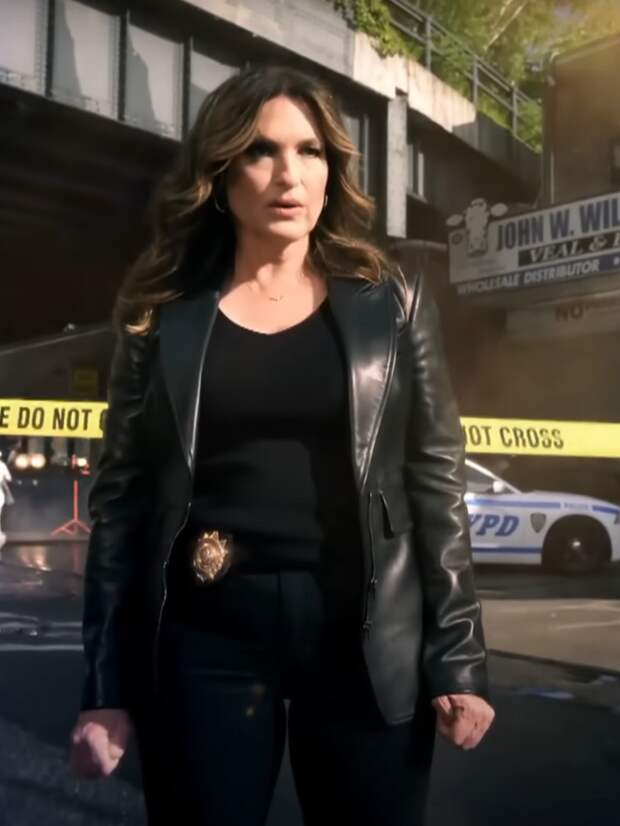 Benson standing in front of police tape staring at the camera on Law & Order: SVU Season 26 Episode 1