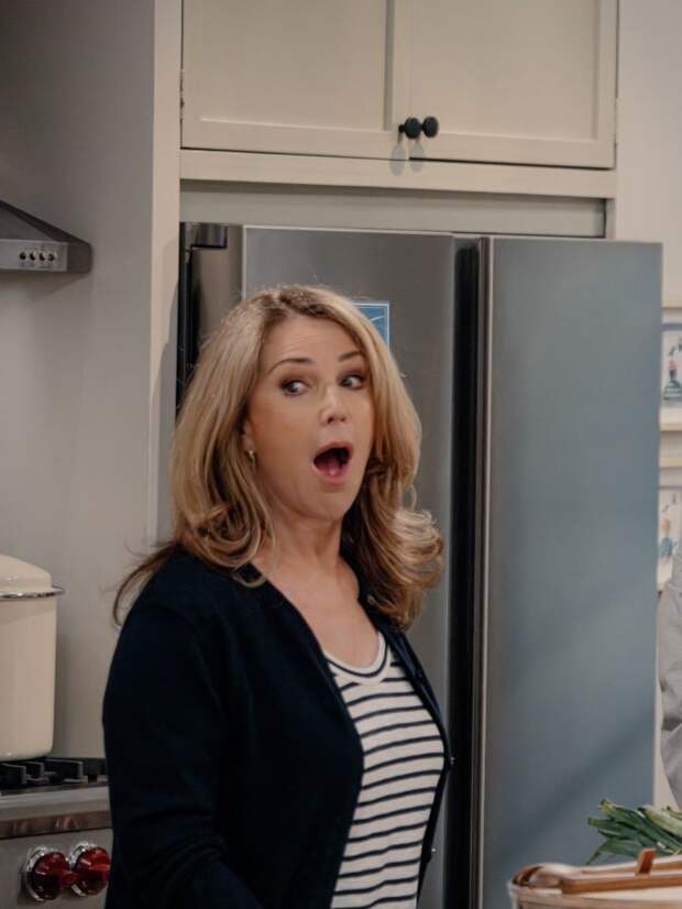 Roz stands in kitchen with mouth open
