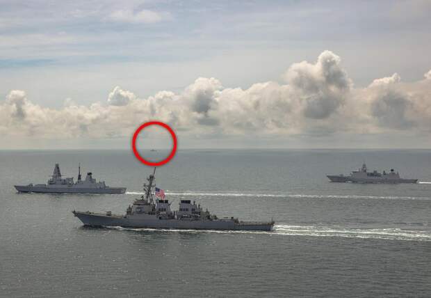 A picture taken on Friday shows a ship from the Russian Black Sea Fleet (circled) shadowing USS Laboon , HMS Defender and the Dutch frigate HNLMS Evertsen