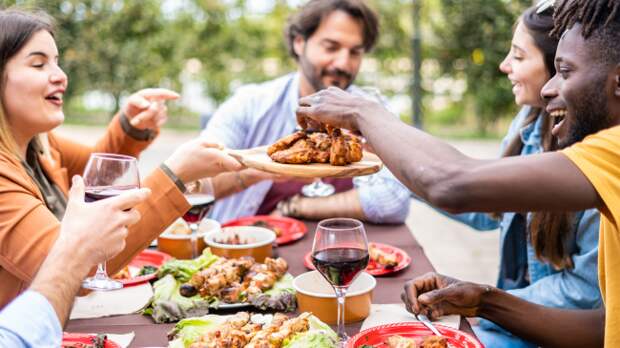 people enjoying meal at picnic table