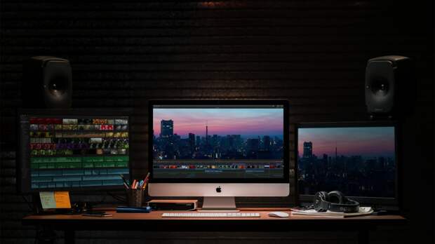 an iMac with two external monitors editing video