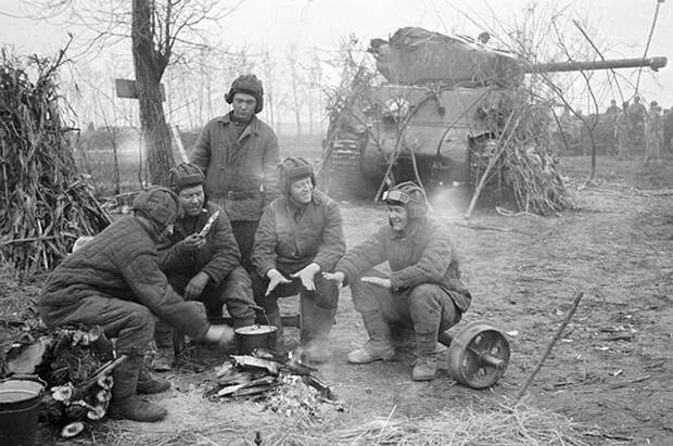 Танкисты отдыхают около костра, рядом танк «Шерман», поставленный по ленд-лизу США. 1-й Прибалтийский фронт, 1944 г.