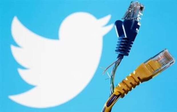 Broken Ethernet cables are seen in front of displayed Twitter logo in this illustration taken October 5, 2021. REUTERS/Dado Ruvic/Illustration 