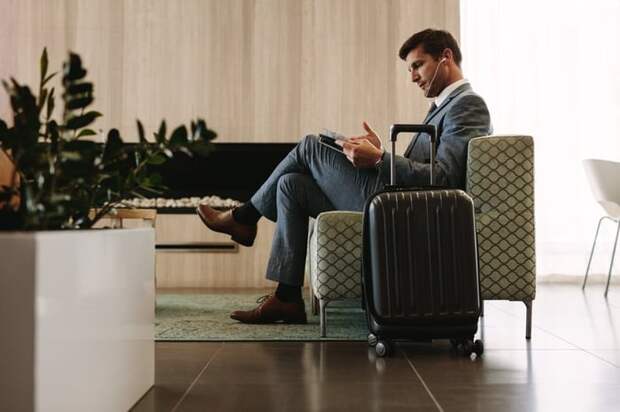 man relaxing in airport lounge