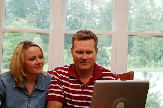 Two people at a laptop.