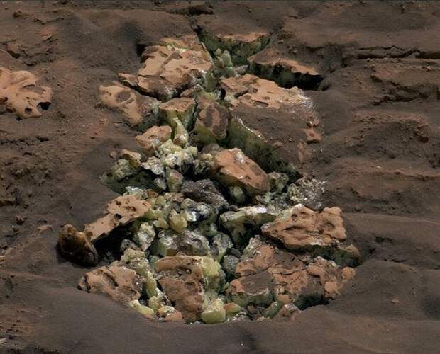 These yellow crystals were revealed after NASA's Curiosity happened to drive over a rock and crack it open on May 30. Using an instrument on the rover's arm, scientists later determined these crystals are elemental sulfur—and it's the first time this kind of sulfur has been found on the Red Planet