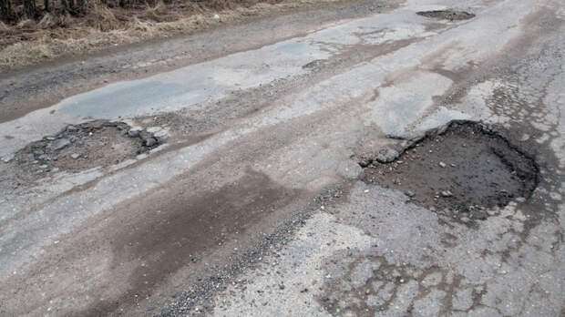 Damaged asphalt road after winter.