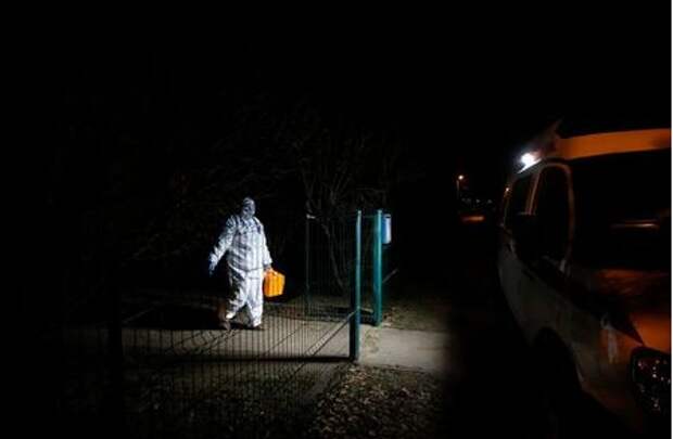 A paramedic wearing personal protective equipment (PPE) walks towards an ambulance as she leaves the house of a patient, amid the outbreak of the coronavirus disease (COVID-19) in the town of Soltsy, Novgorod Region, Russia December 10, 2020. Picture taken December 10, 2020. REUTERS/Anton Vaganov