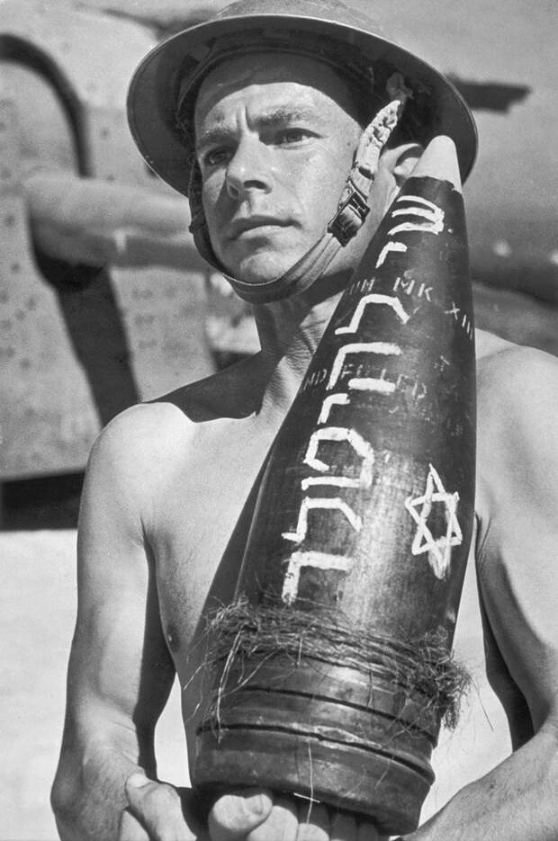 Jewish Brigade soldier Joseph Wald, holding an artillery shell bearing the inscription Gift for Hitler. Italy, 1944-1945