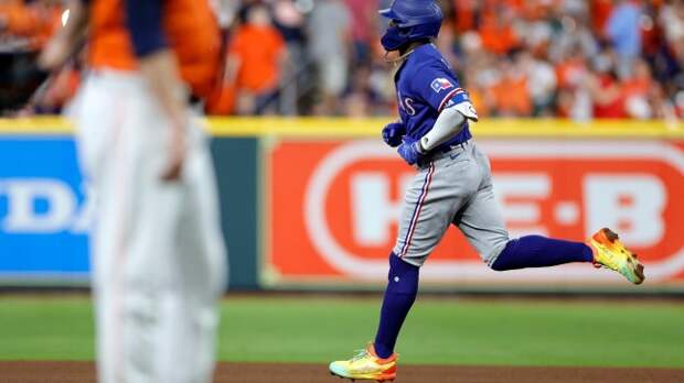 Adolis Garcia rounds the bases after hitting a grand slam.