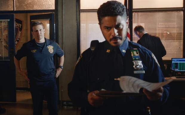Badillo looks angrily at a paper while Jamie stands with his hands on hips on Blue Bloods Seaso 14 Episode 17.