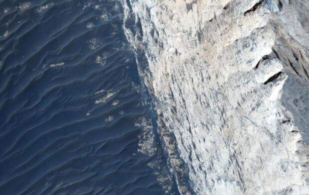 A view of Ophir Chasma on the northern portion of the vast Mars canyon system, Vallles Marineris, taken by NASA's Mars Reconnaissance Orbiter.