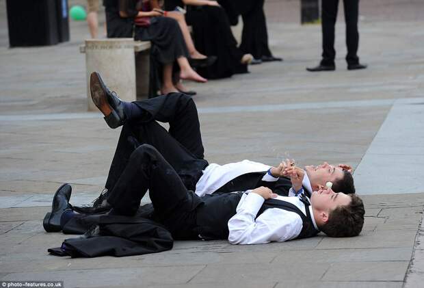 The laughing students took a well-earned cigarette break as they gazed up at the sky following a night of partying