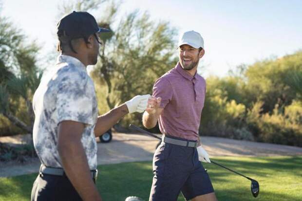 Two men golfing in VRST golf apparel