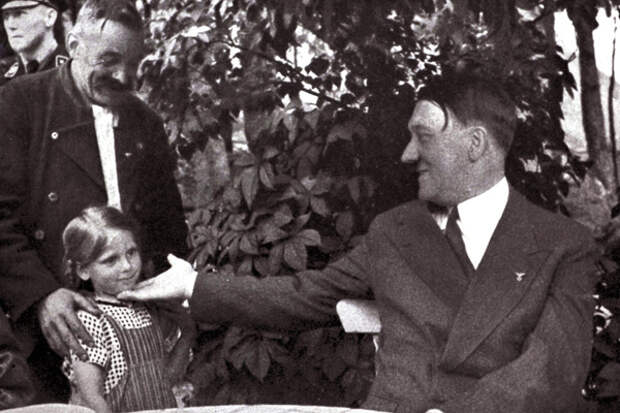 Adolf Hitler 1889-1945. German politician and the leader of the Nazi Party greets a young girl