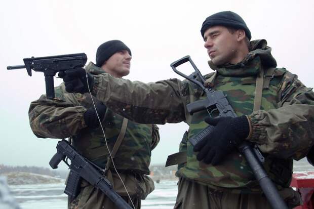 Krasnoarmeysk, Moscow Region, Russia, 29/10/2010. Members of Russian special forces inspect silenced weapons displayed by a dealer at training training exercise at a military base outside Moscow. The exercise was part of the Interpolitex 2010 state security exhibition.