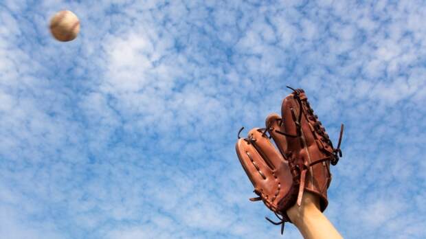 A fielder tries to catch a baseball.
