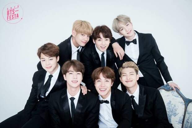 The members are (from left to right) TOP: V, Jungkook, Suga, and BOTTOM: Jimin, Jin, J-Hope, Rap Monster.