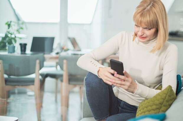 Woman uncomfortable by what she's reading on her phone.