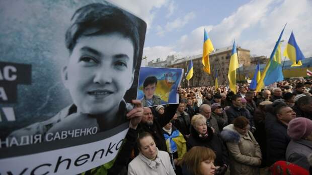 People hold posters depicting Ukrainian pilot Nadezhda Savchenko, during a interfaith prayer "For Ukraine, for peace, for Nadezhda" in support of Ukrainian pilot Nadezhda Savchenko in Kiev, Ukraine, Sunday, March 1, 2015. Ukrainian pilot Nadezhda Savchenko was captured by Russia-backed rebels during fighting in eastern Ukraine. The Kiev government has so far been unsuccessful in seeking the extradition of Savchenko who was elected a member of the Ukrainian parliament in the October 2014 Ukrainian parliamentary election. (AP Photo/Sergei Chuzavkov)